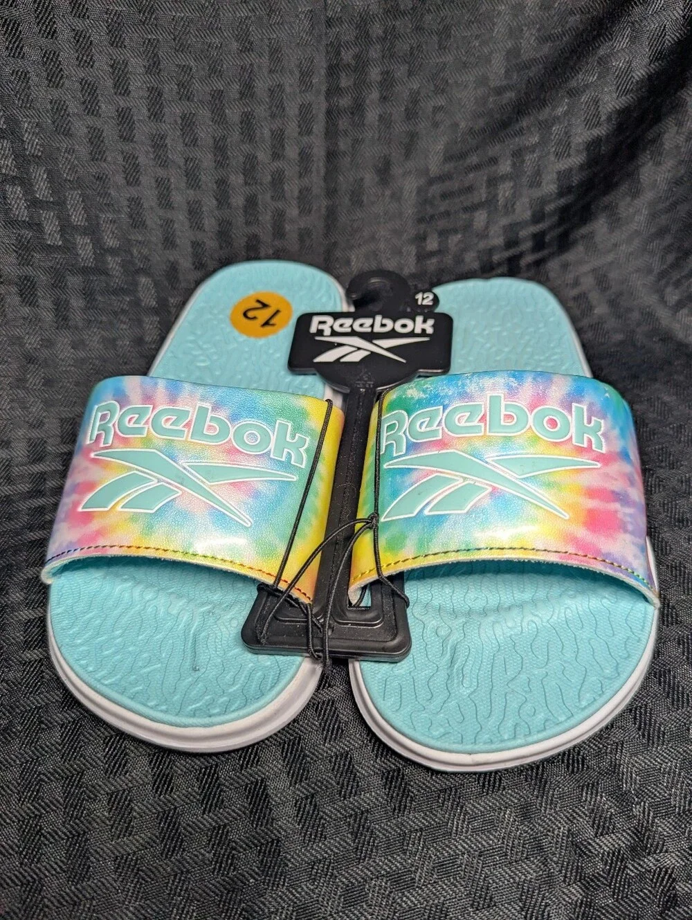 Aqua & Tie-Dye Reebok Slide Sandals.